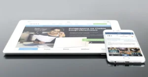 Modern tablet and smartphone displaying web content on a reflective surface, highlighting technology and connectivity